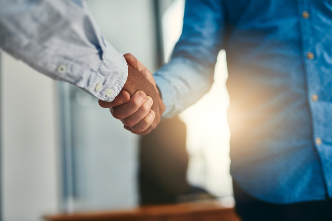 Handshake between business staff member and a client